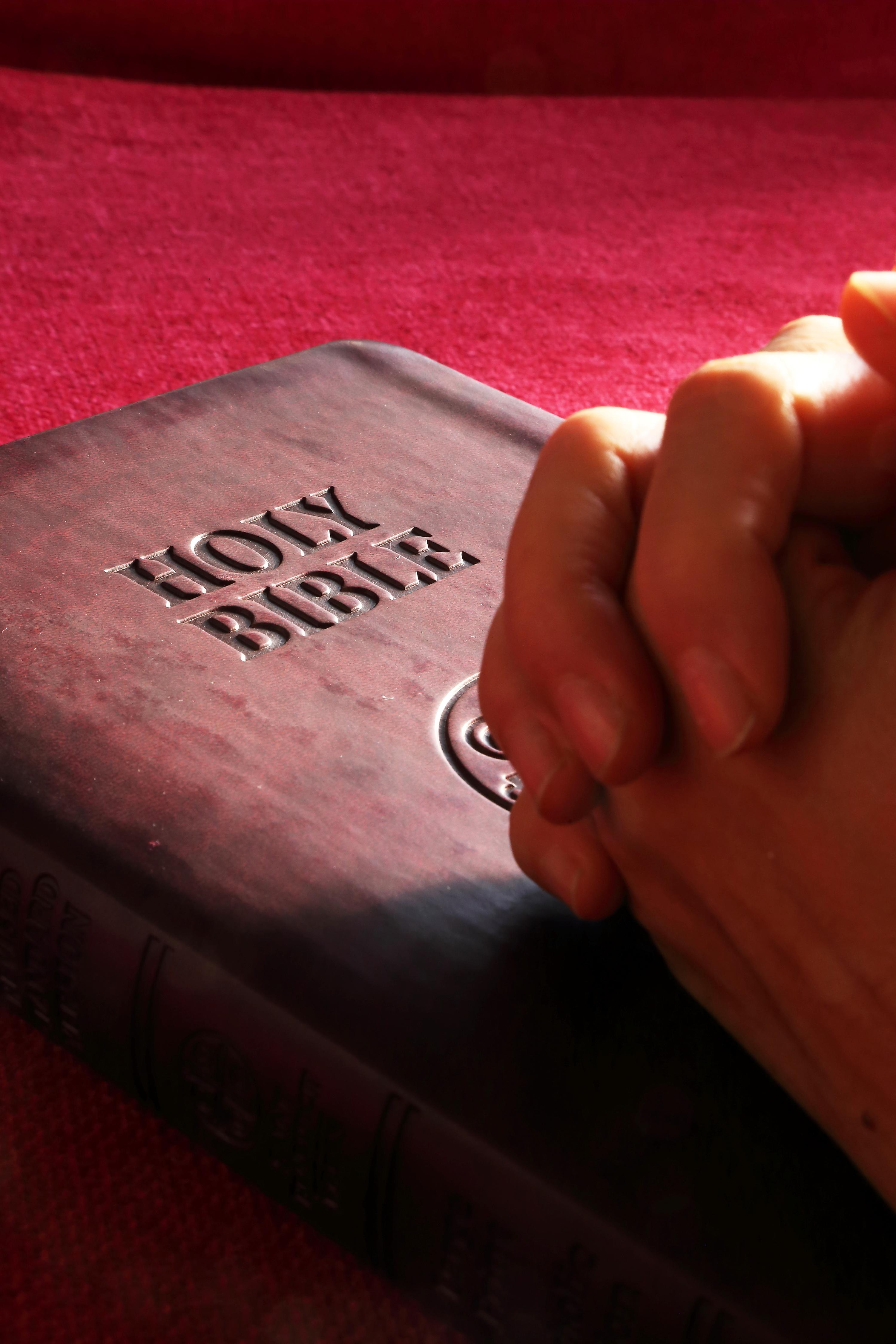 praying_on_bible_red