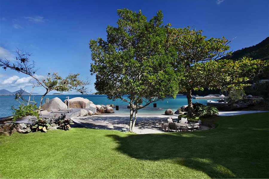 A private beach and dock flank this tranquil southern Brazilian home with impressive mountain and water views. A private beach and dock flank this tranquil southern Brazilian home with impressive mountain and water views.