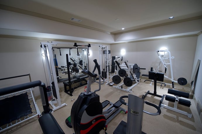 The home gym has recessed lighting and a mirrored wall, plus enough room for a full suite of exercise equipment and free weights. The home gym has recessed lighting and a mirrored wall, plus enough room for a full suite of exercise equipment and free weights.