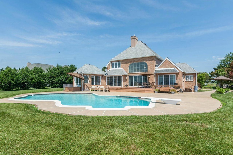 The living room’s French doors open onto a patio and provide stellar views of Chesapeake Bay. The living room’s French doors open onto a patio and provide stellar views of Chesapeake Bay.