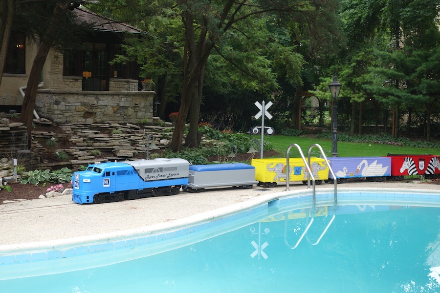 A miniature train traverses the grounds of this Tudor-style estate, adding a pop of color and a welcome touch of whimsey to its elegant grounds. A miniature train traverses the grounds of this Tudor-style estate, adding a pop of color and a welcome touch of whimsey to its elegant grounds.