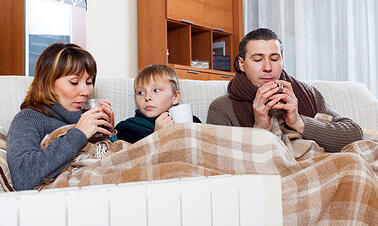 photodune-6957709-freezing-family-of-three-warming-near-warm-radiator-xs