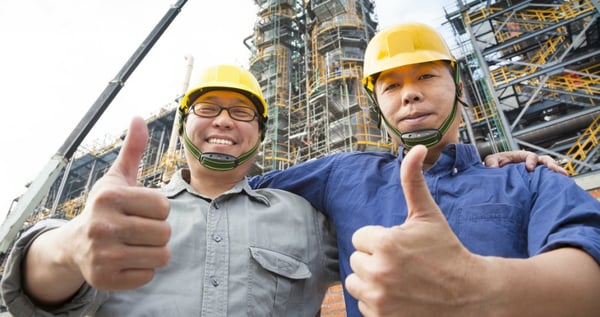 factory workers showing thumbs up