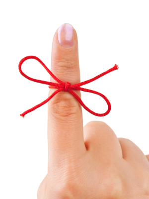 red ribbon on finger