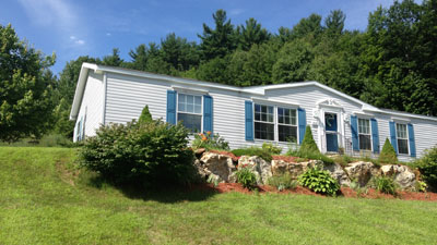 A modern manufactured home on a hill