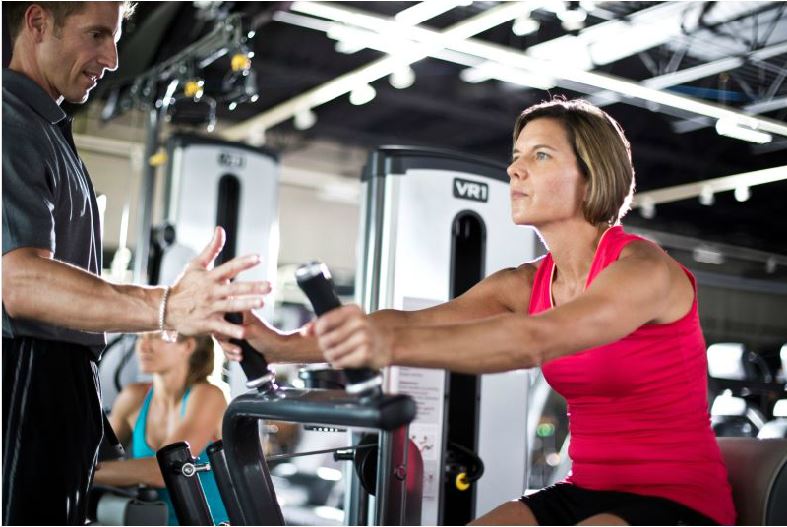 Woman using weight machine