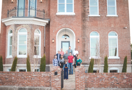 The members of Aerial Development Group in front of a recently-finished project.