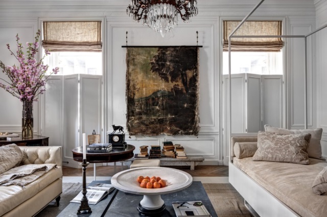 An Aubusson rug in muted gold colors allows you to mix contemporary furniture and traditional art as in this living room.