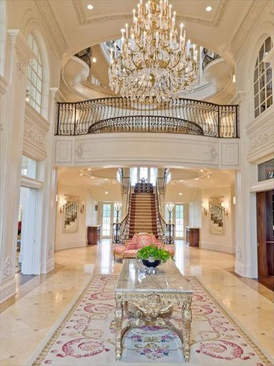 Aubusson rugs are often used to create a grand look as in the hallway of this palatial California home.