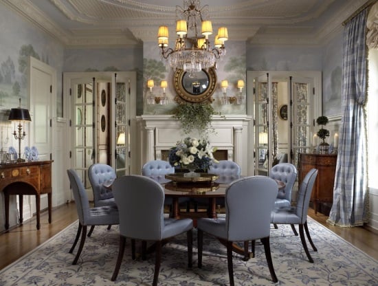 A cream and blue floral rug brings elegance to traditional dining room by Scott Snyder