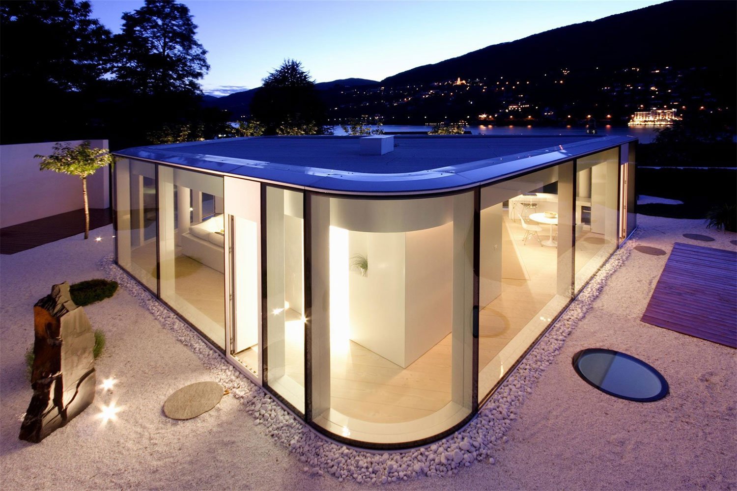 This villa is enveloped in glass to take full advantage of its location on Lake Lugano with state-of-the-art materials, luxurious finishes, and designer furniture..