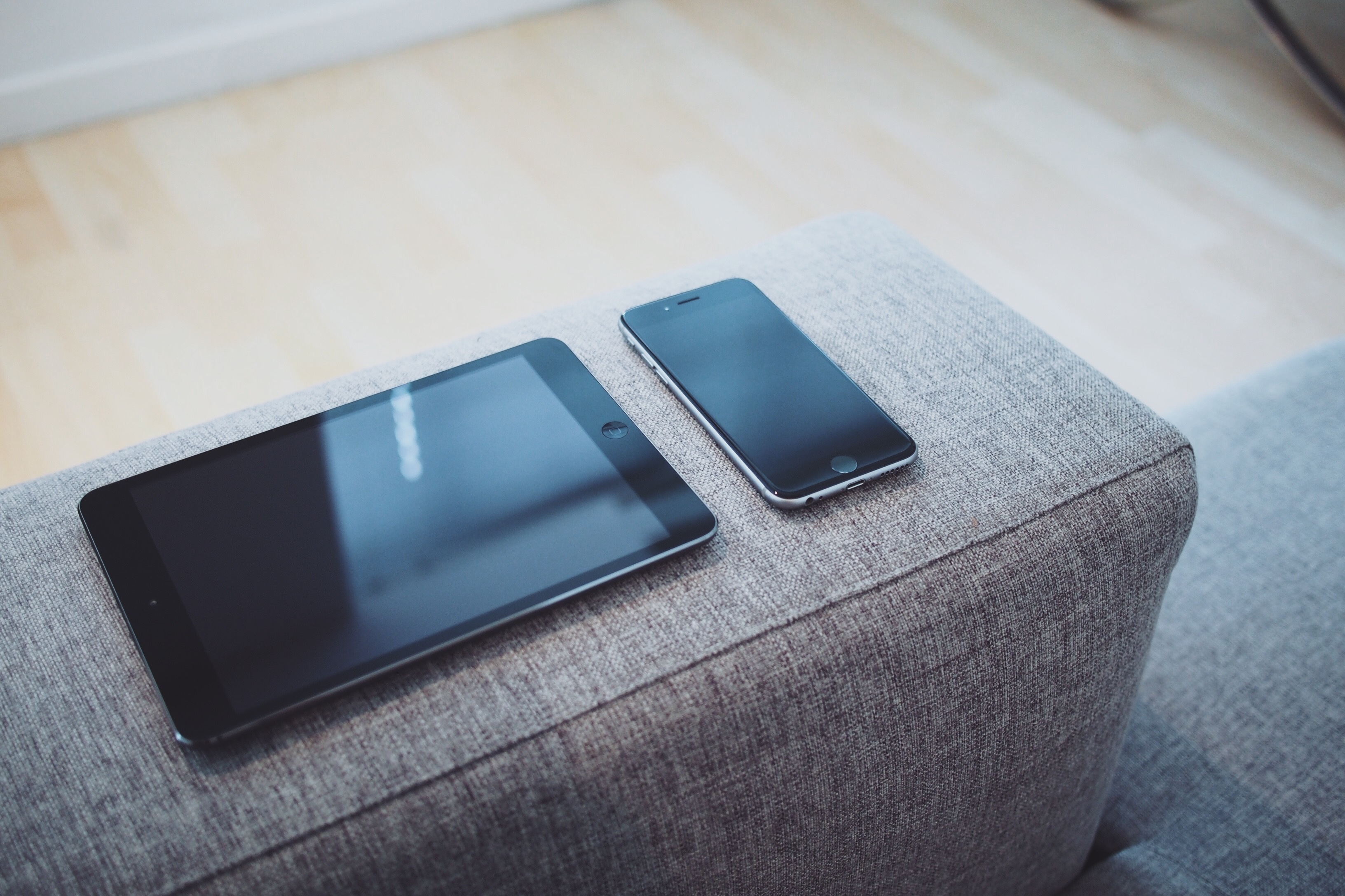 mobile devices on a couch arm