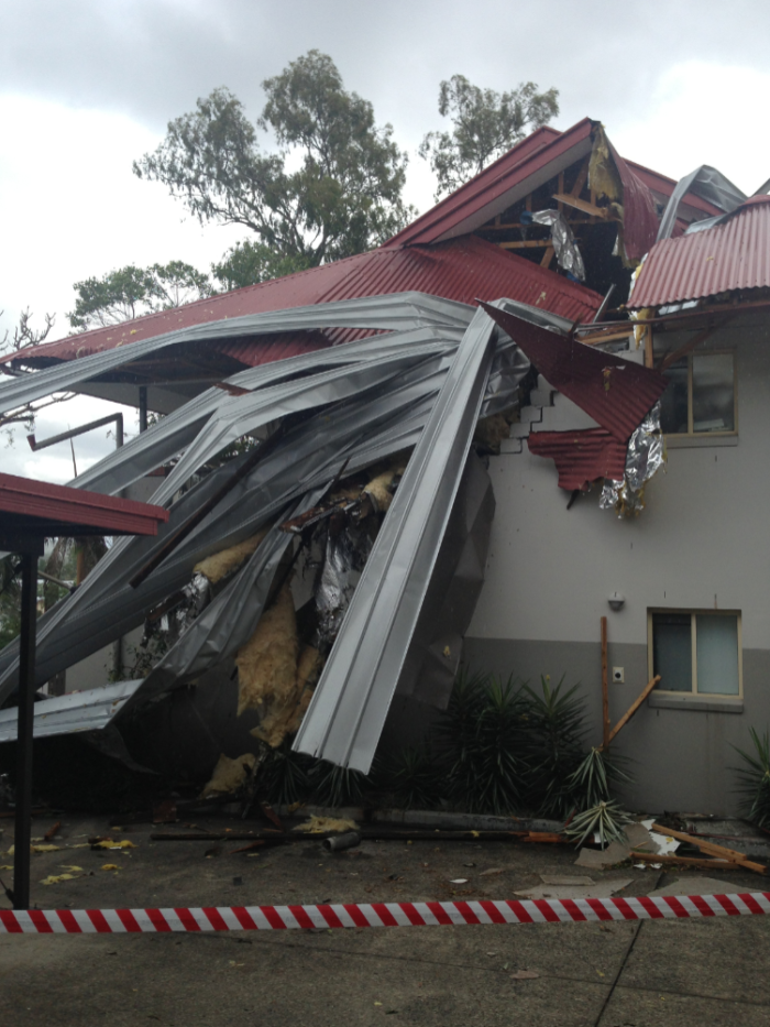 Twisted metal roof sheets removed during storm