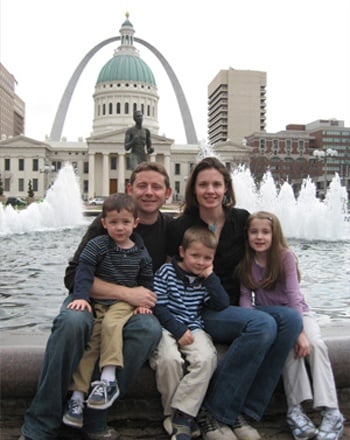 family together in front of arch