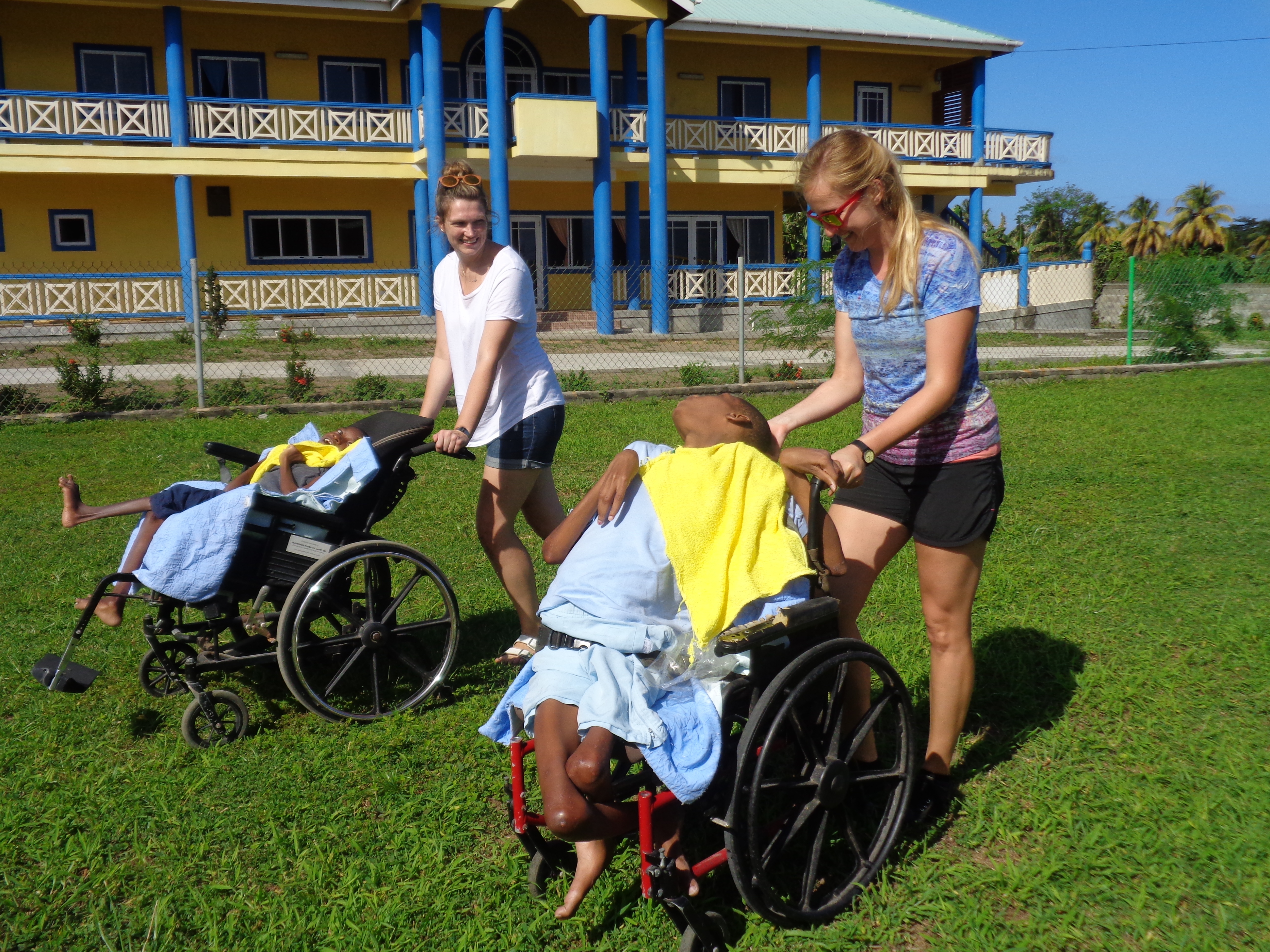 Wheelchair_bound_children_being_driven_around.jpg