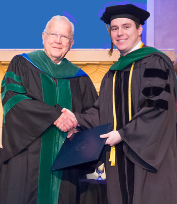 Dr. Saling shakes hands with Trinity chancellor Dr. Skelton