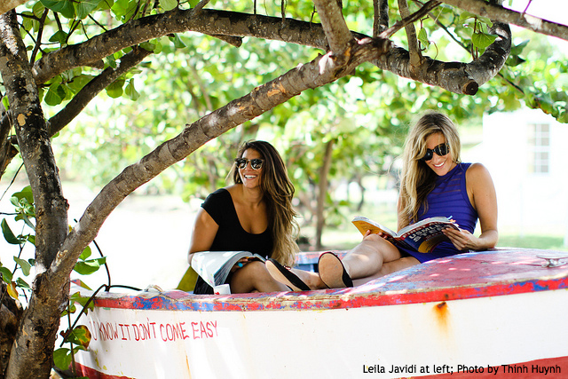 two women studying in a boat