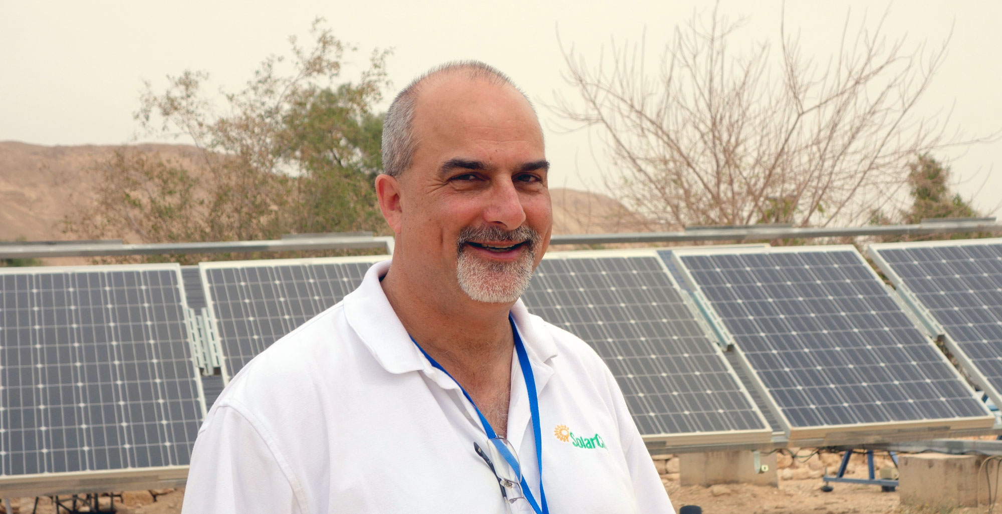 photo of David Arfin in front of a solar installation