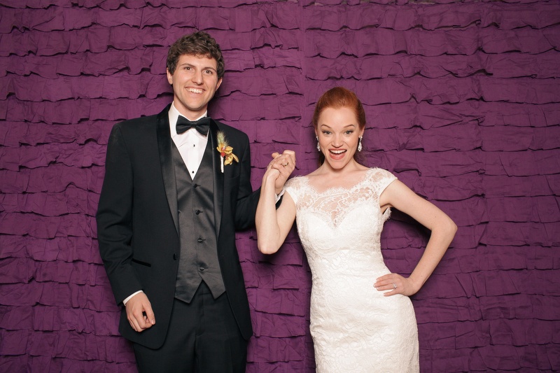 A young couple enjoying the photobooth at their wedding.