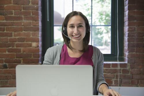 at computer with headset, take issues out of the spotlight, reach out through phone or email, engaging with customers, handling negative feedback, social media, garden media group