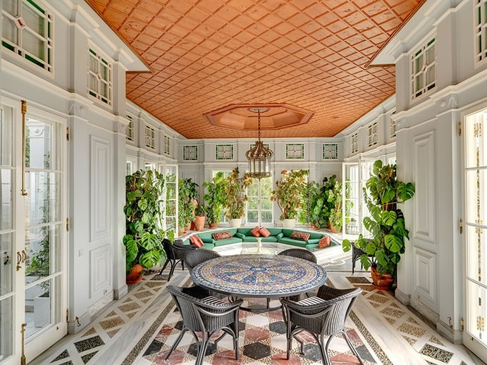 The interior of this Provençal-style home on the outskirts of Athens is bathed in warm light thanks to large windows overlooking the pristine gardens. Photograph: Ploumis Sotiropoulos The interior of this Provençal-style home on the outskirts of Athens is bathed in warm light thanks to large windows overlooking the pristine gardens. Photograph: Ploumis Sotiropoulos