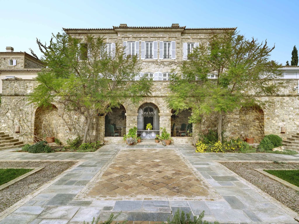 Perched on a hill in the Athenian countryside, Villa Mareza is a grand provençal-style stone villa surrounded by nearly nine acres of grounds with neoclassical gardens and resort-worthy features.