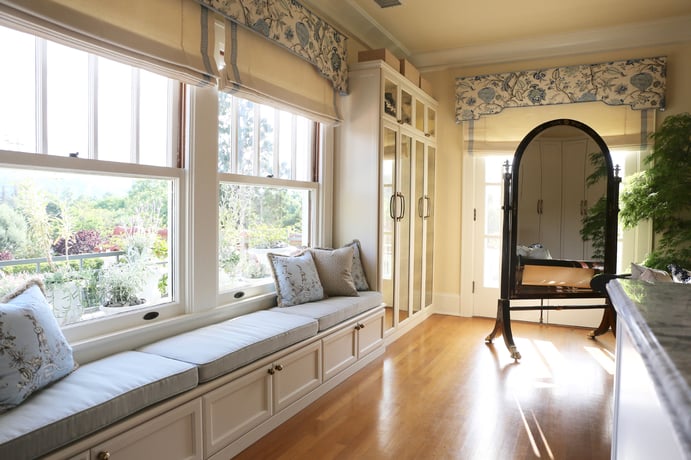 This California home’s walk-in wardrobe and dressing room is appointed with custom-designed built-ins including several closets, a center island, and banquette; chandeliers and huge windows provide ample light. This California home’s walk-in wardrobe and dressing room is appointed with custom-designed built-ins including several closets, a center island, and banquette; chandeliers and huge windows provide ample light.