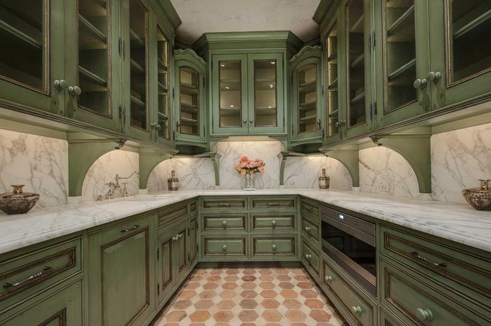The kitchen also features fine wood details, as well as beautiful marble countertops, and the home’s signature color: a perfect shade of green. The kitchen also features fine wood details, as well as beautiful marble countertops, and the home’s signature color: a perfect shade of green.