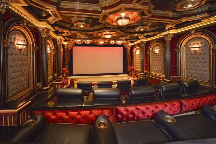 Framed by a beautiful Art-Deco inspired theater, this elegant home’s commercial-grade screen and projection system is valued at around $80,000. Wall sconces, Corinthian columns, and a decorative ceiling create an Old Hollywood atmosphere. Framed by a beautiful Art-Deco inspired theater, this elegant home’s commercial-grade screen and projection system is valued at around $80,000. Wall sconces, Corinthian columns, and a decorative ceiling create an Old Hollywood atmosphere.