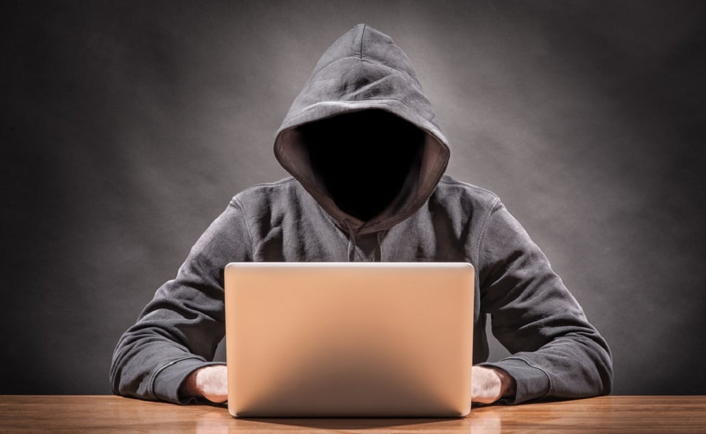 masked man on laptop_cyber security