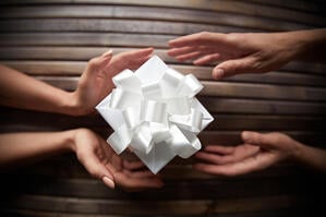 Paper origami with people holding it