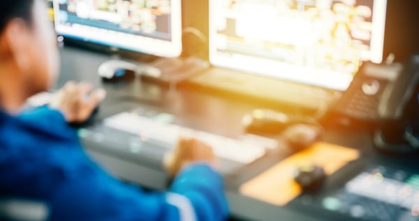 A factory worker working at the computer