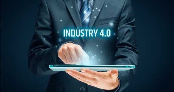 Man looking at ipad with Industry 4.0 above as text
