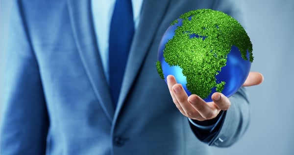 man in suit holding globe