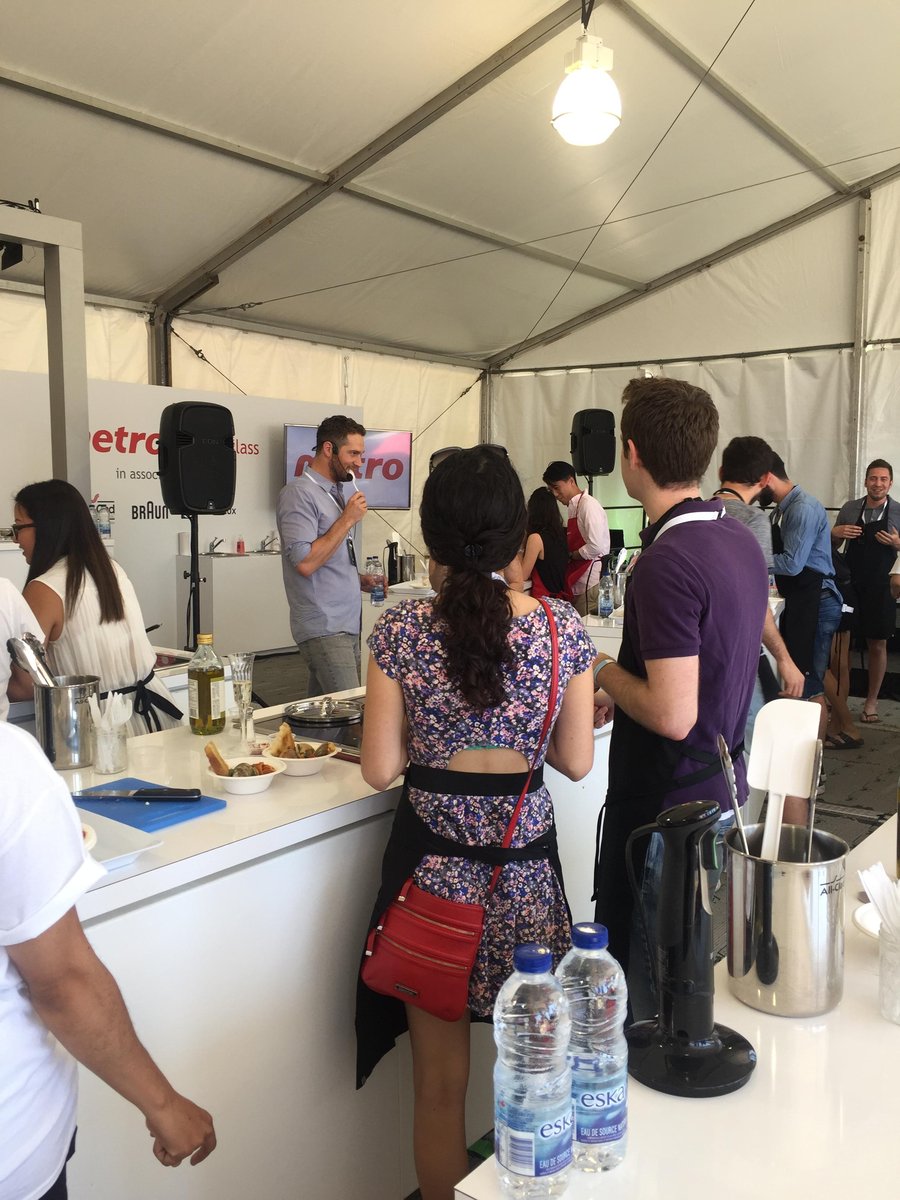 Cory Vitiello guiding a cooking class with people standing at tables