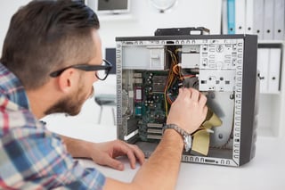 Computer engineer working on broken console in his office.jpeg