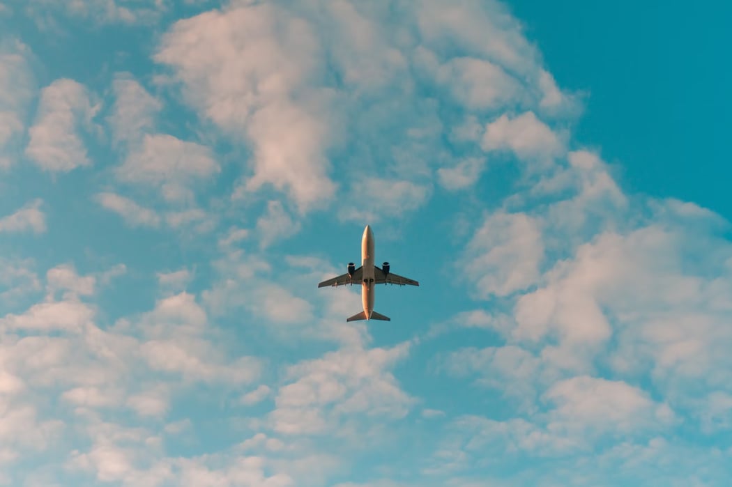 An airplane flying across a blue sky.