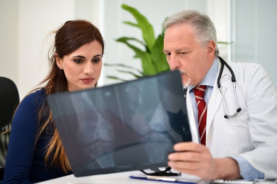doctor and patient looking at xrays