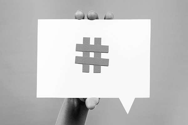 The hashtag sign on a white speech bubble, showing its importance for social media marketing strategy