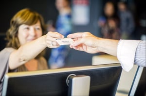 visitor receiving a badge at the reception