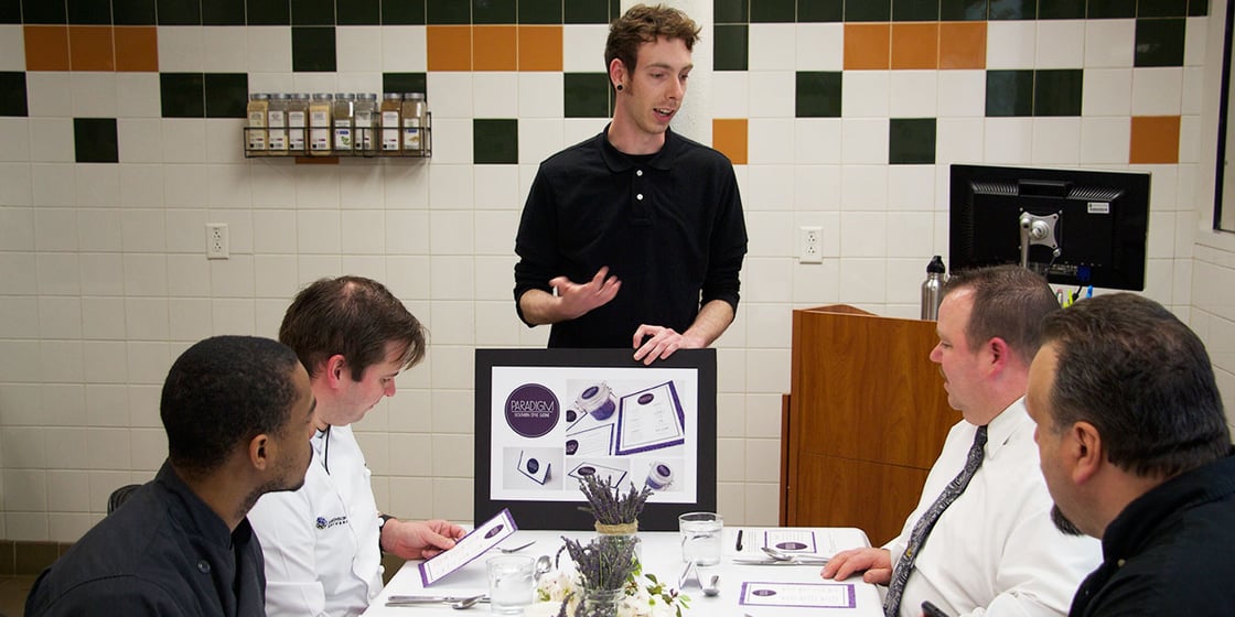 Shane Ranger & Jordan Lozier worked with culinary students in Chef Melanson's class to develop Paradigm. Graphic Design & Digital Media student explaining the concept behind pop-up restaurant Paradigm
