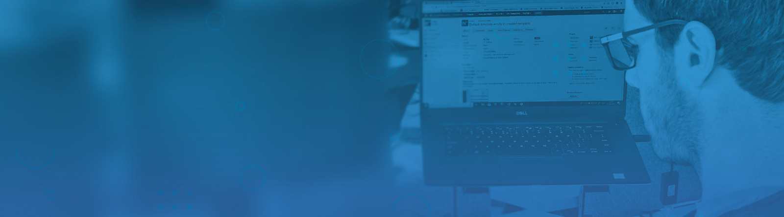 We have a new Nmbrs Tech Blog! The image shows one of our developers working in front of three screens.