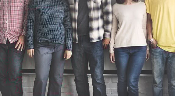 Three people stood up against a wall to represent buyer personas