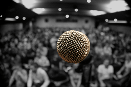 Microphone stand in front of an audience