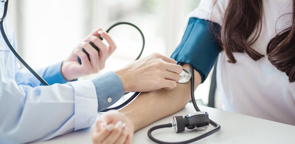 Doctor taking blood pressure