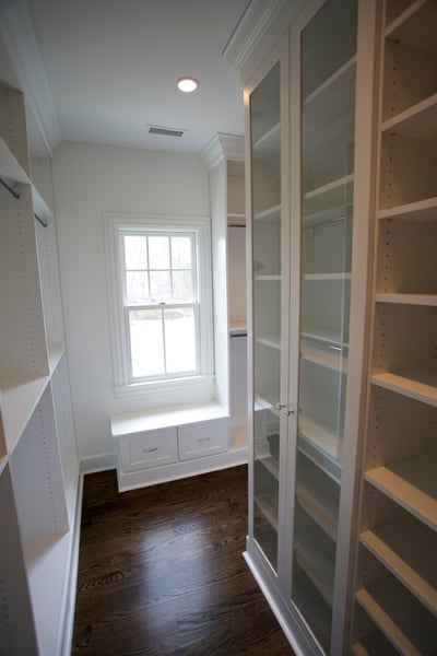 White Walk In with Custom Full Height Island, Bench Seat, Raised Panel Drawers, Mullion Doors