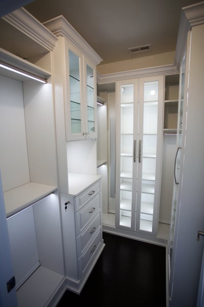 Latitude North walk In Closet with Square Style Hutch, LED Closet Lighting, Mullion Doors, Glass Shelves, Decorative Base and Crown Mouldings