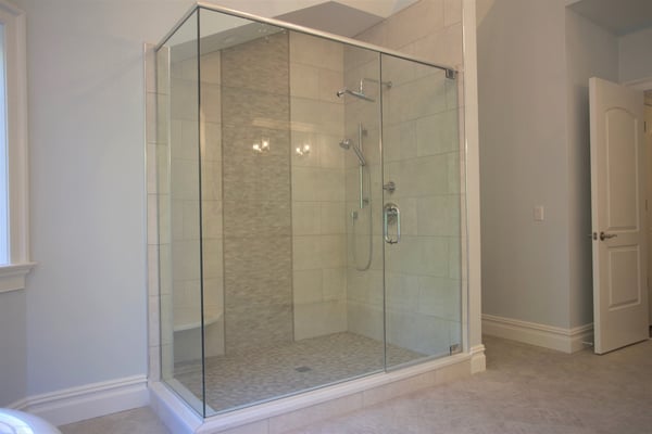 Frameless Door & Panel Shower Enclosure with Full Height Return, Header, and Pivot Hinges