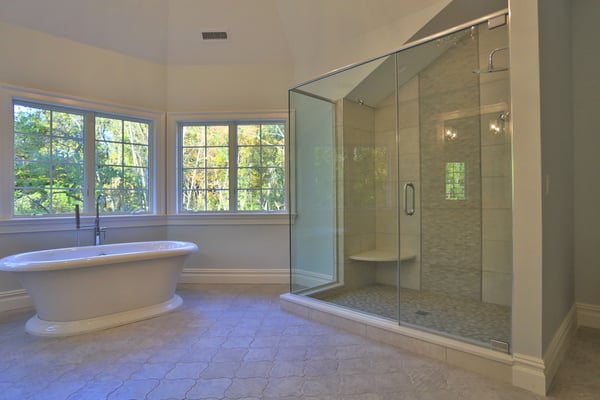 Frameless Door & Panel Shower Enclosure with Full Height Return, Header, and Pivot Hinges