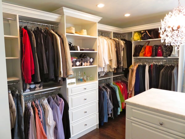 custom walk in closet with drawers and shelves and island